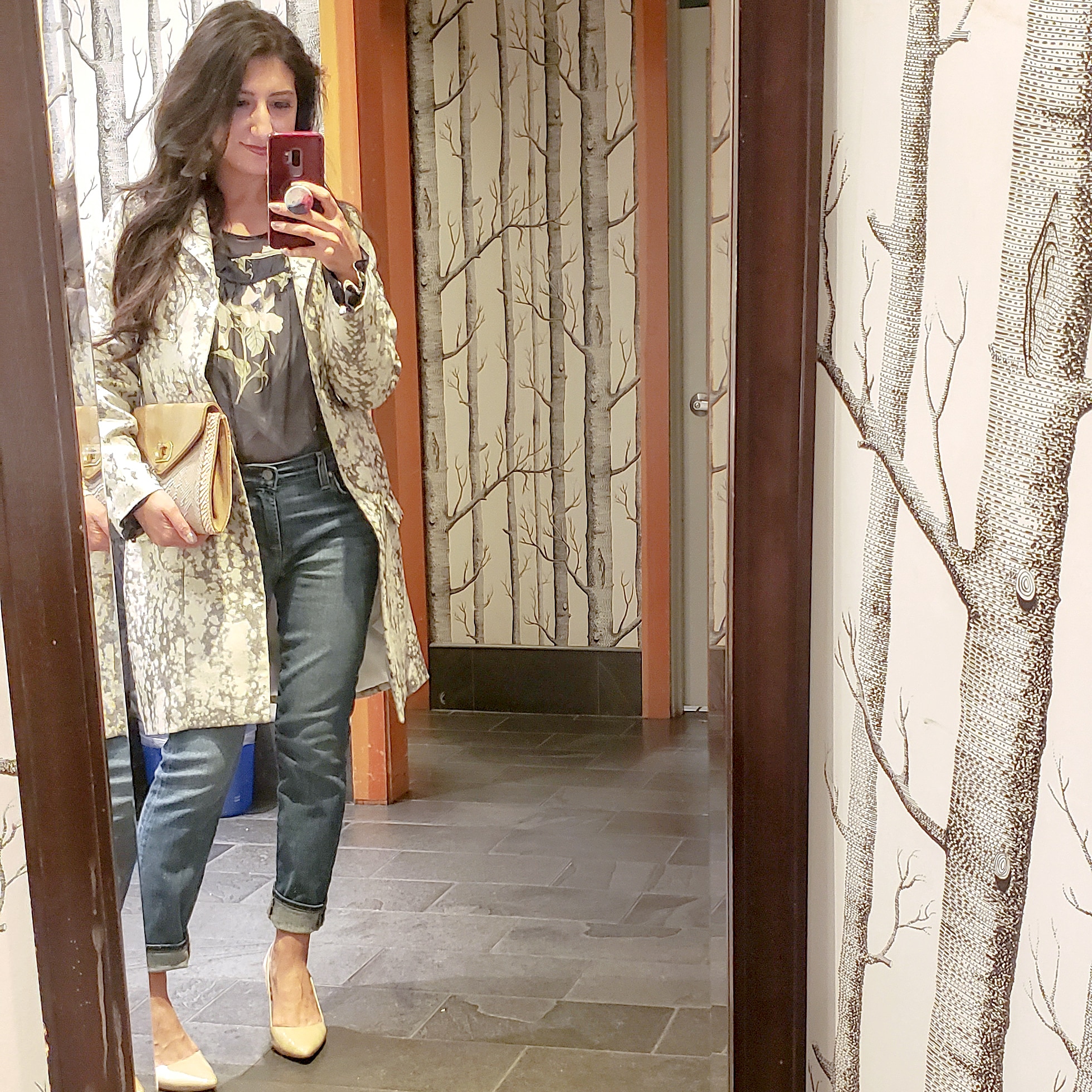 mirror selfie in a floral blouse and rolled up jeans